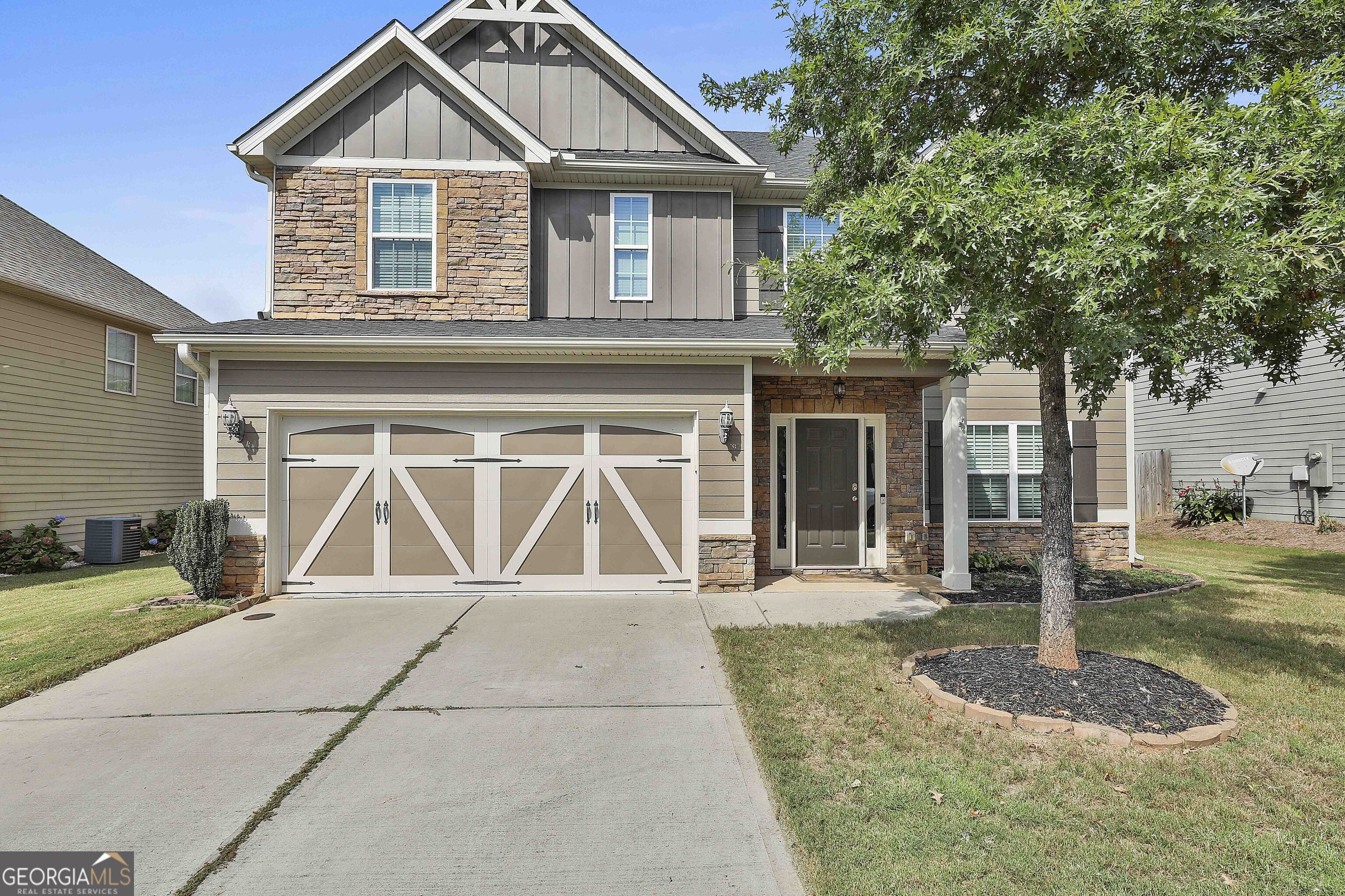 a front view of a house with a yard and garage