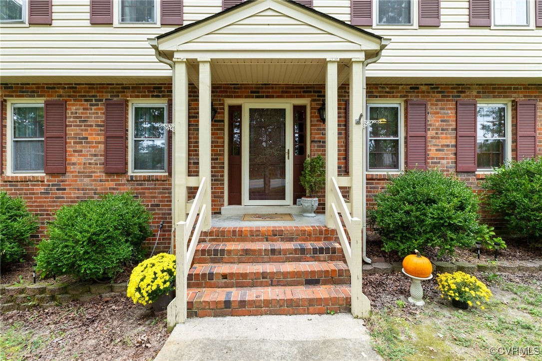 a front view of a house with outdoor seating and plants