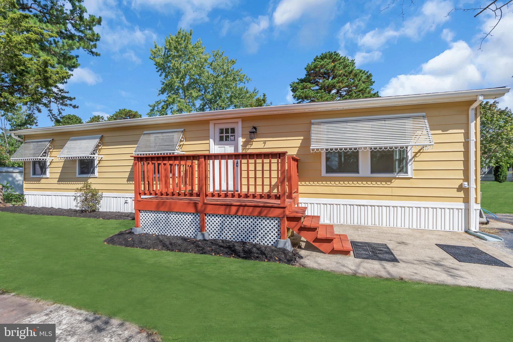 a view of a house with a yard and furniture