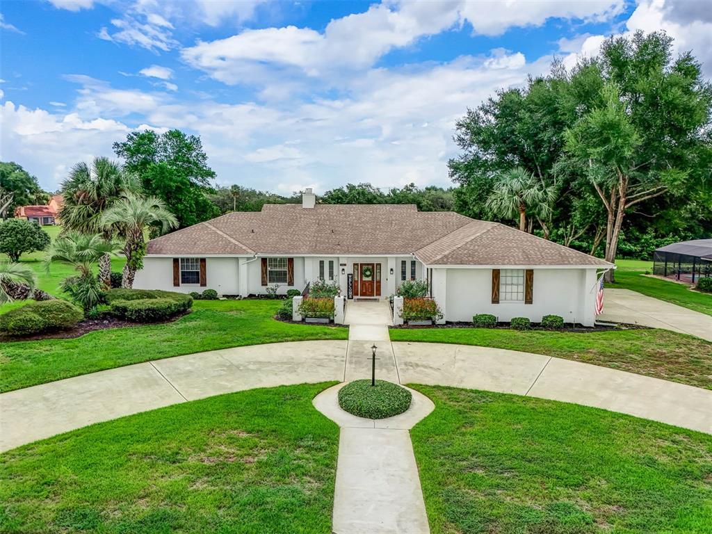 a front view of a house with yard and green space