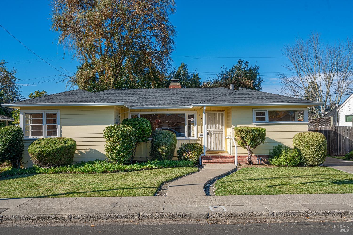 a front view of a house with a garden