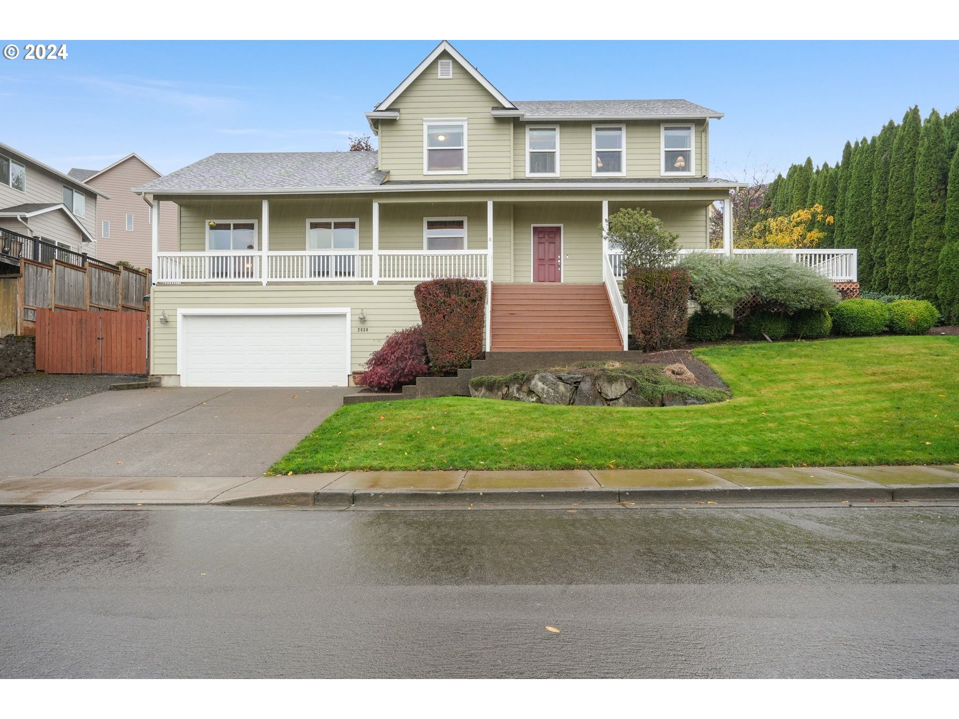 a front view of a house with a yard and a garage