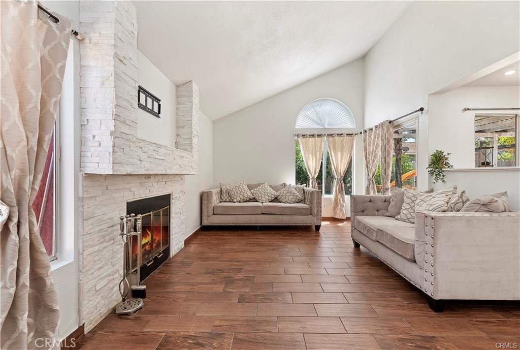 a living room with furniture and a fireplace