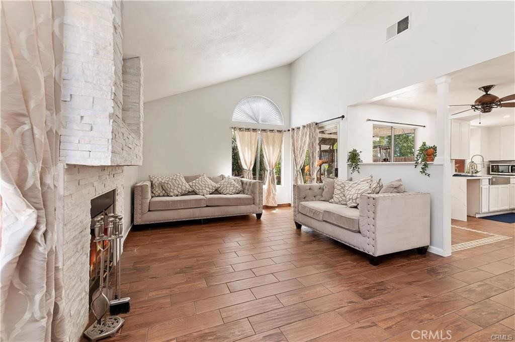 a living room with furniture and a fireplace