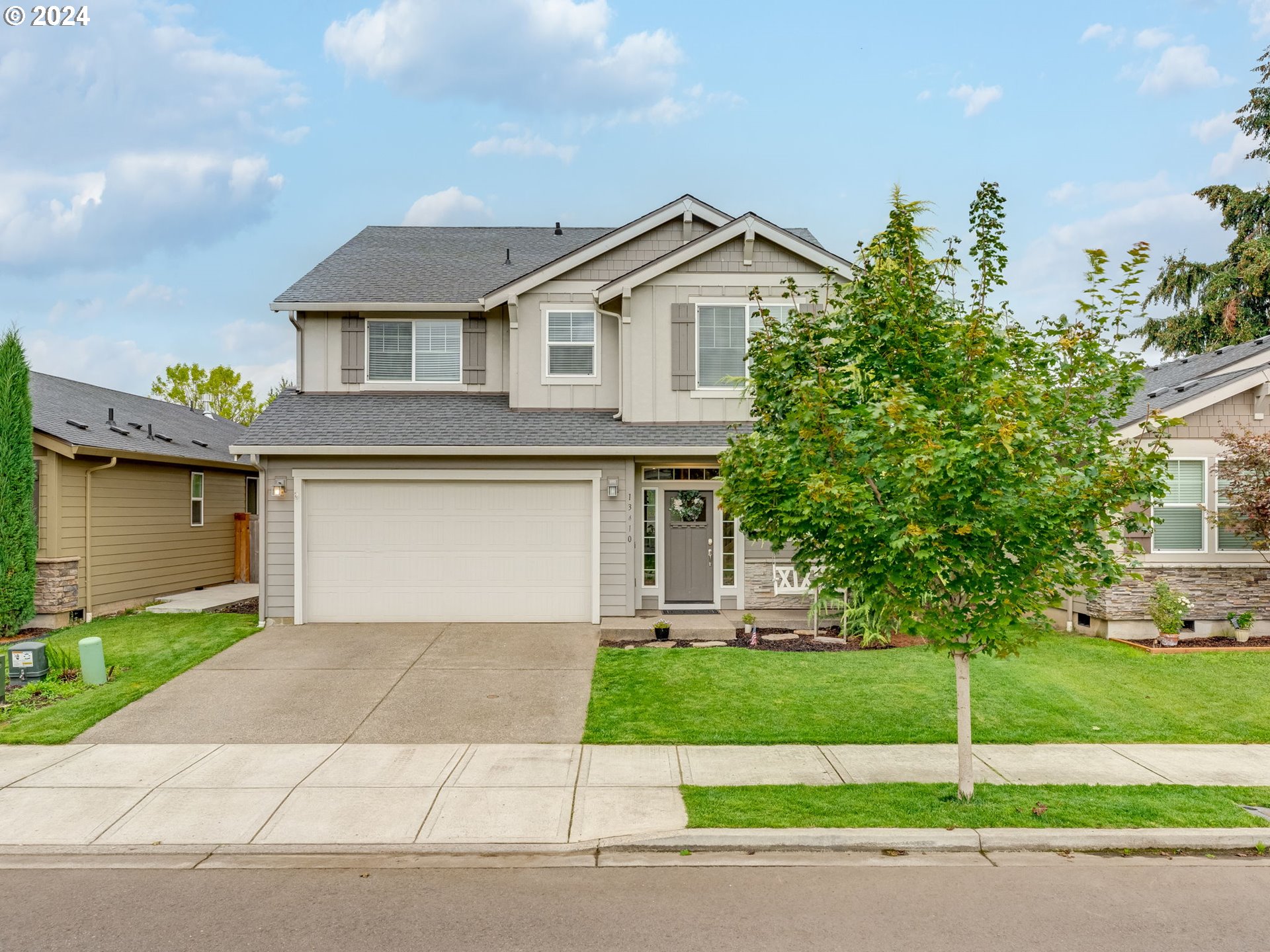 a front view of a house with a yard and garage