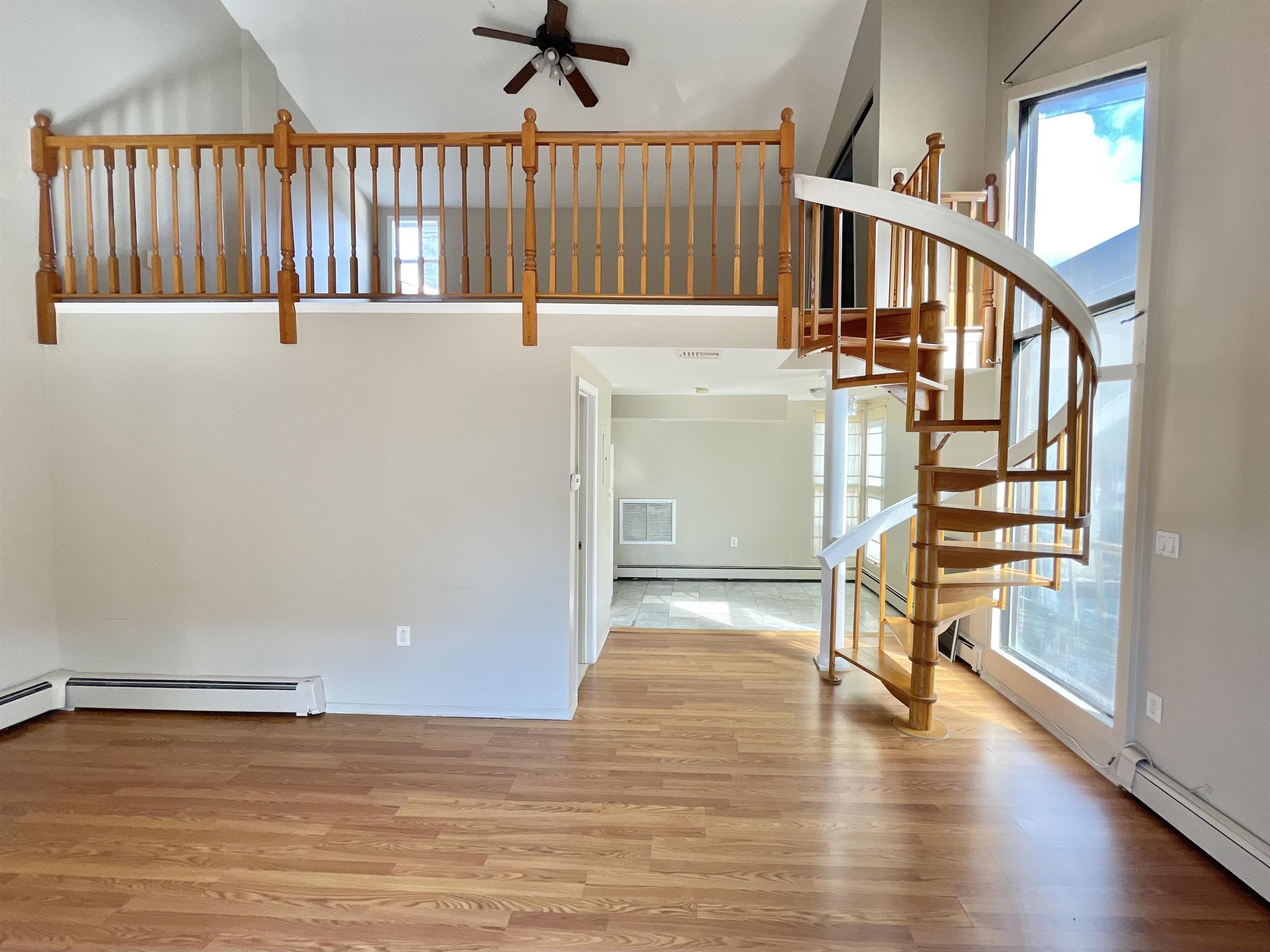 a view of an entryway with wooden floor