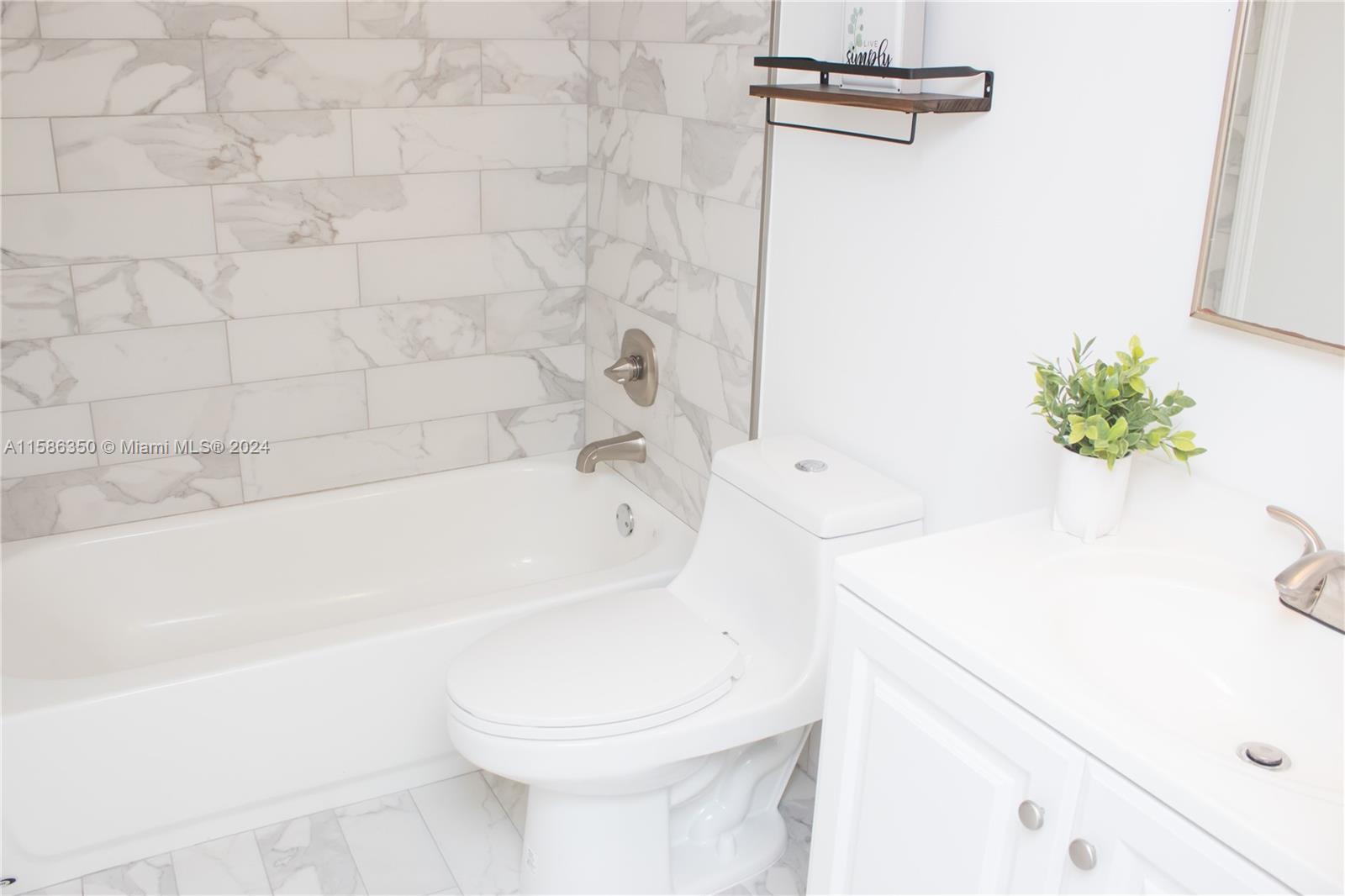 a bathroom with a sink a toilet and tub