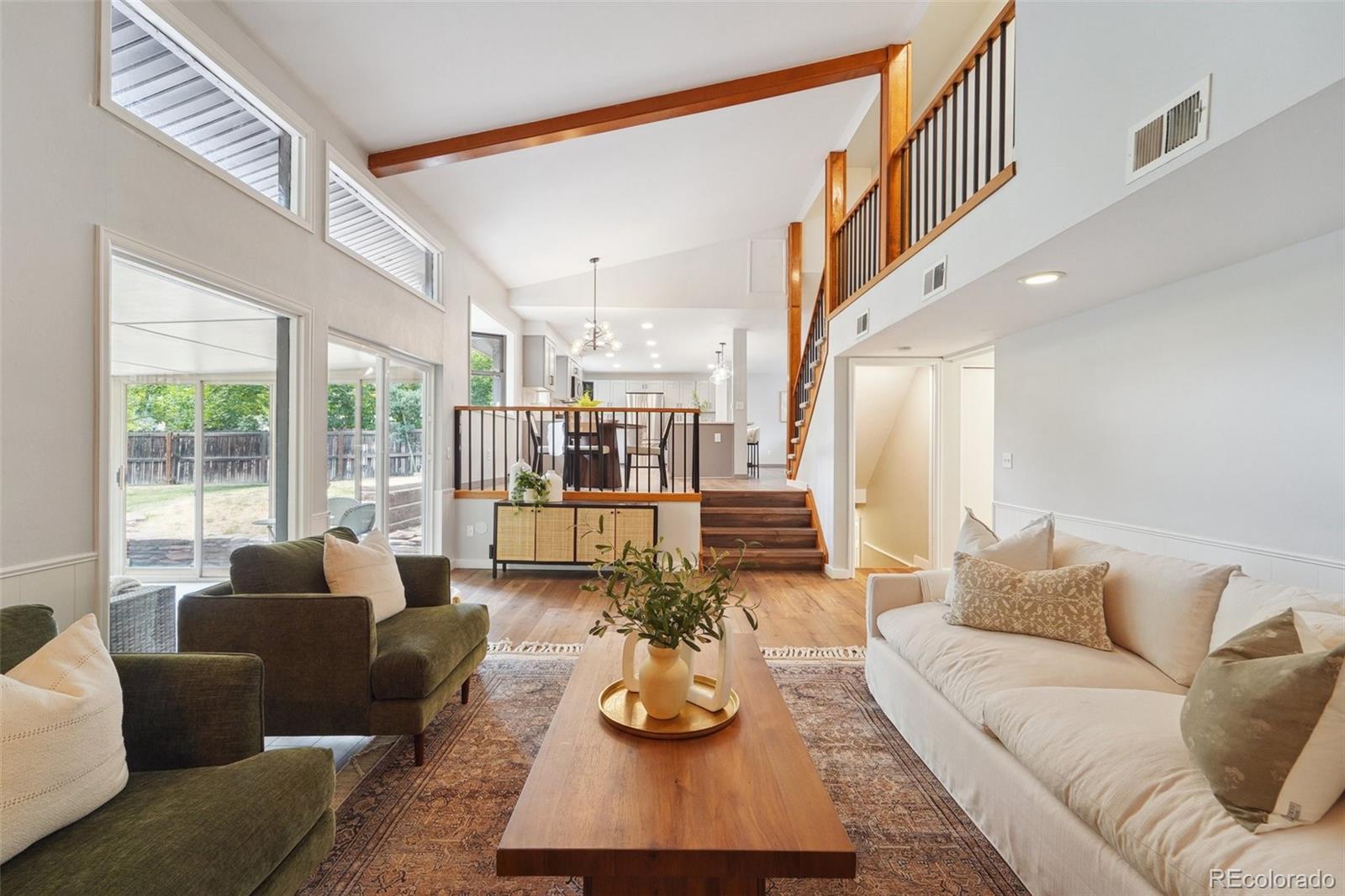 a living room with furniture fireplace and large windows