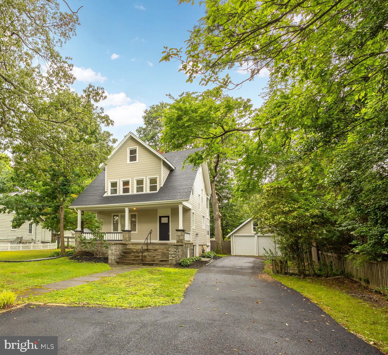 a front view of a house with yard and green space