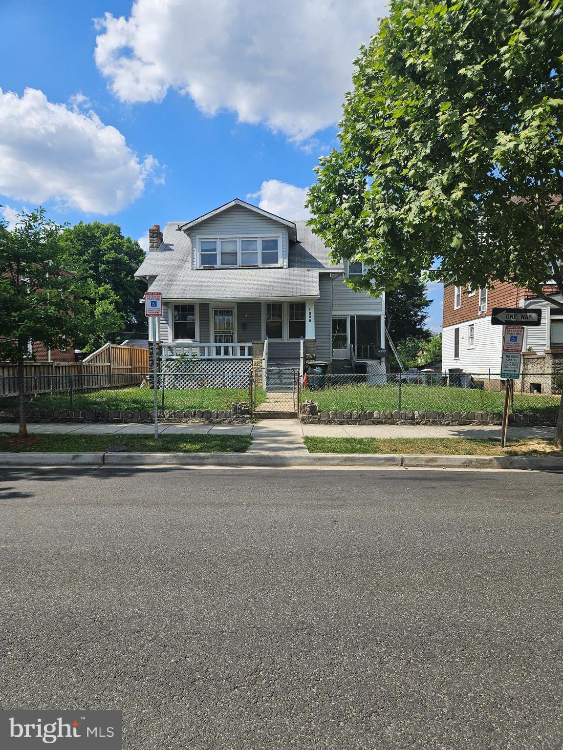 a front view of a house with a garden and plants