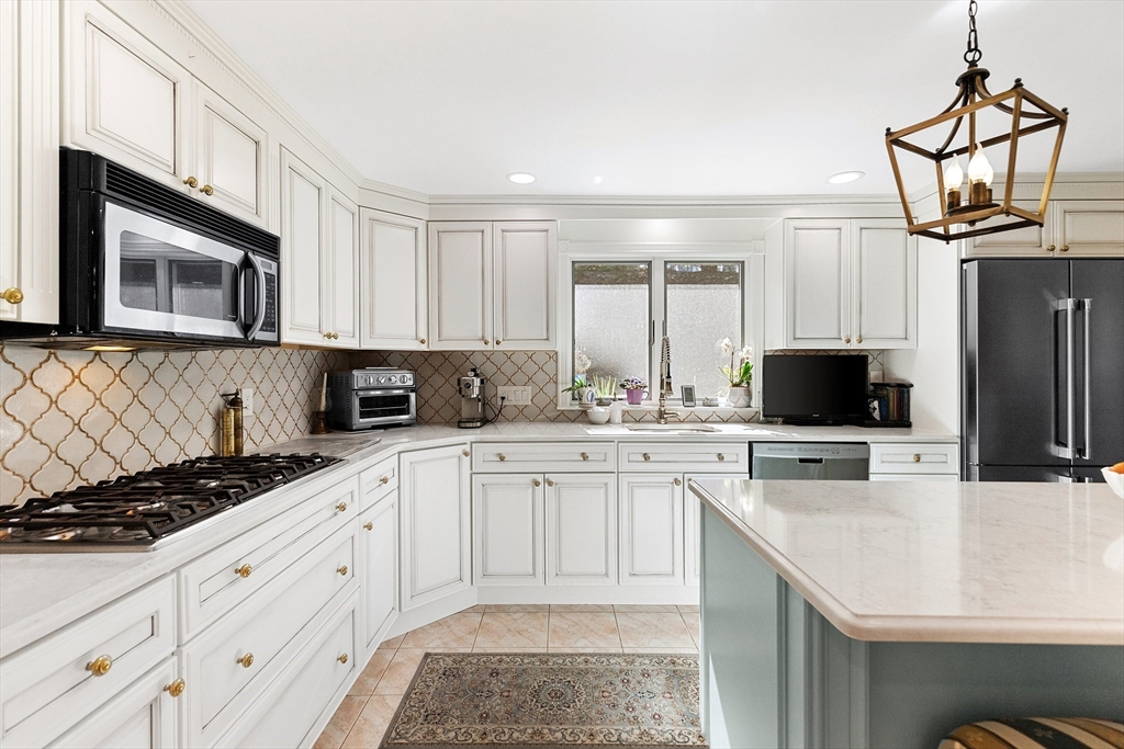 a kitchen with a sink stove and microwave