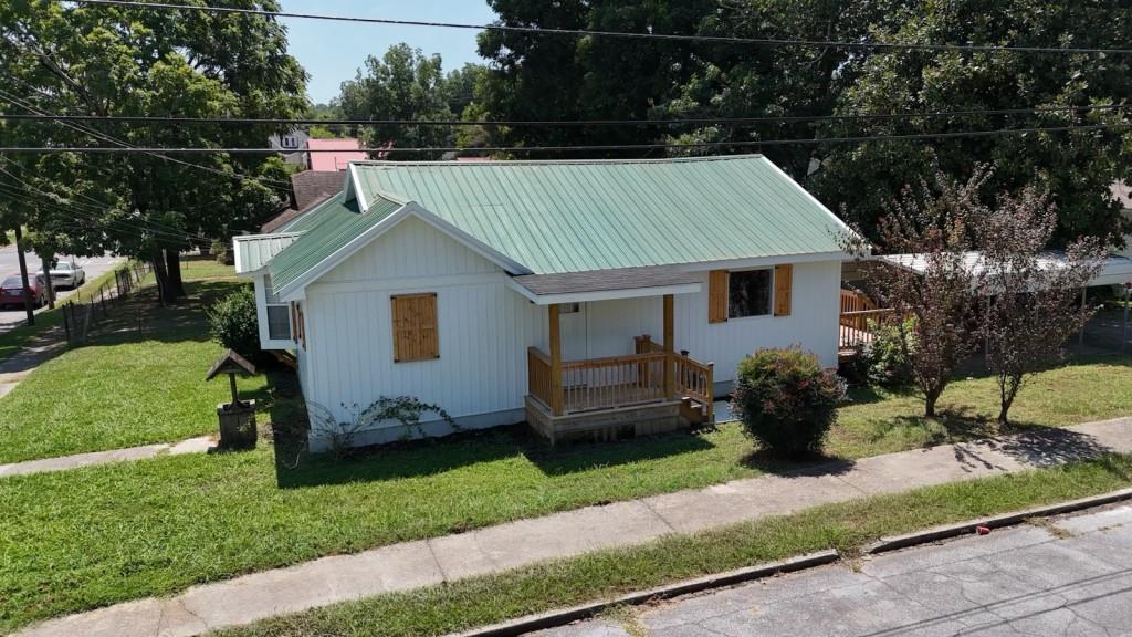 a view of a house with a back yard and a garden