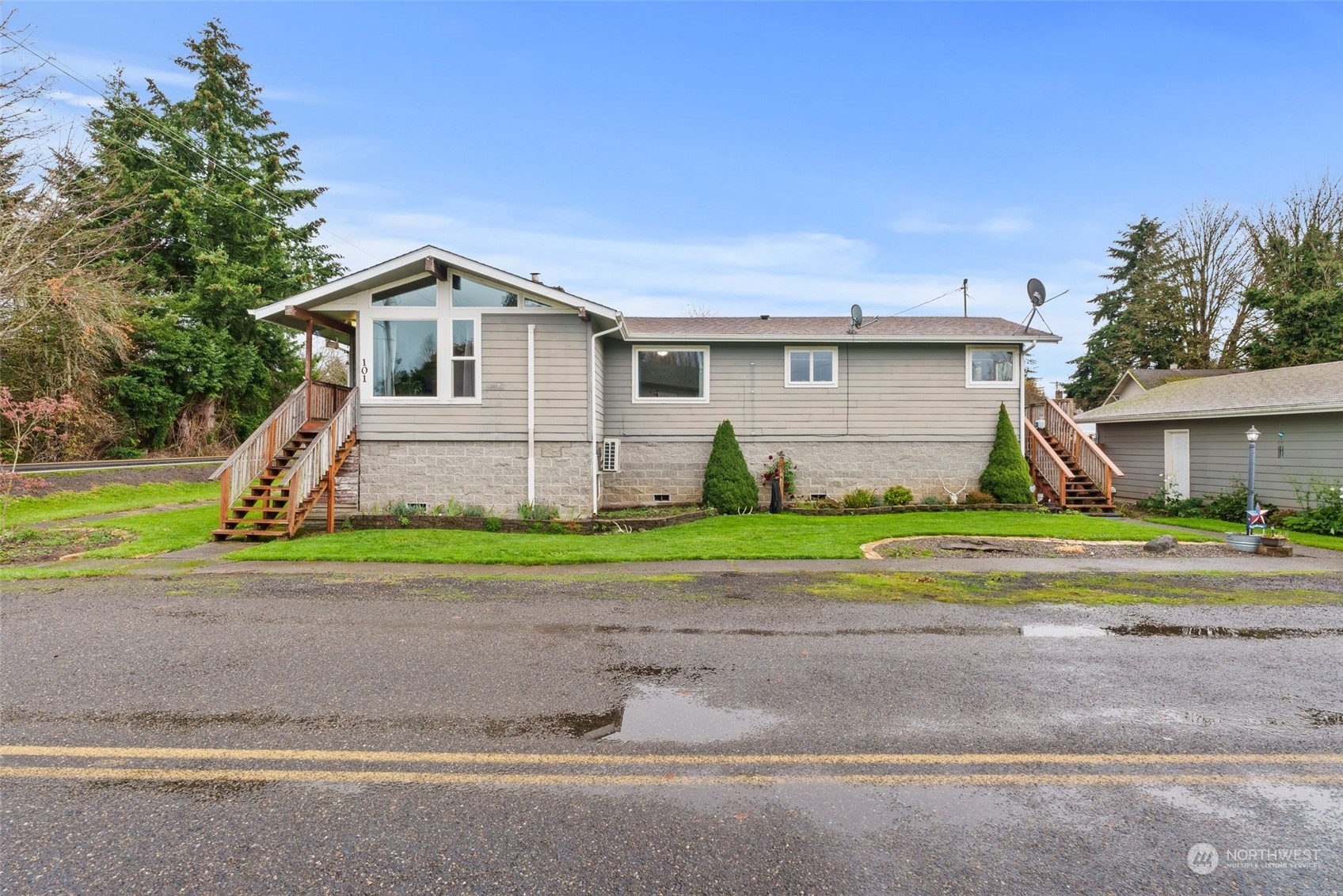 a front view of house with yard and green space