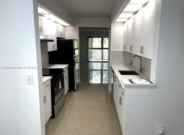 a kitchen with a refrigerator and a stove top oven