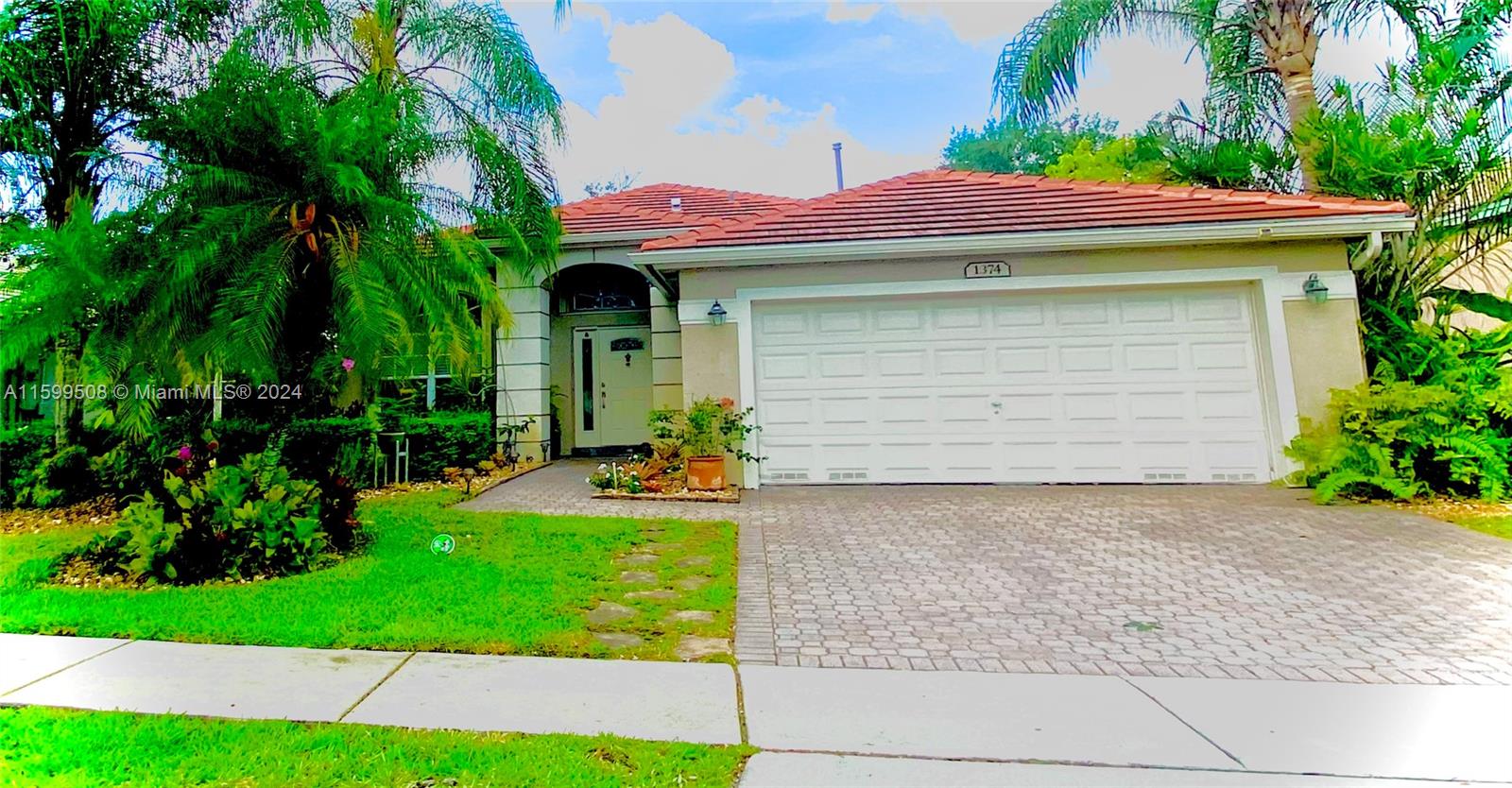 a front view of a house with garden