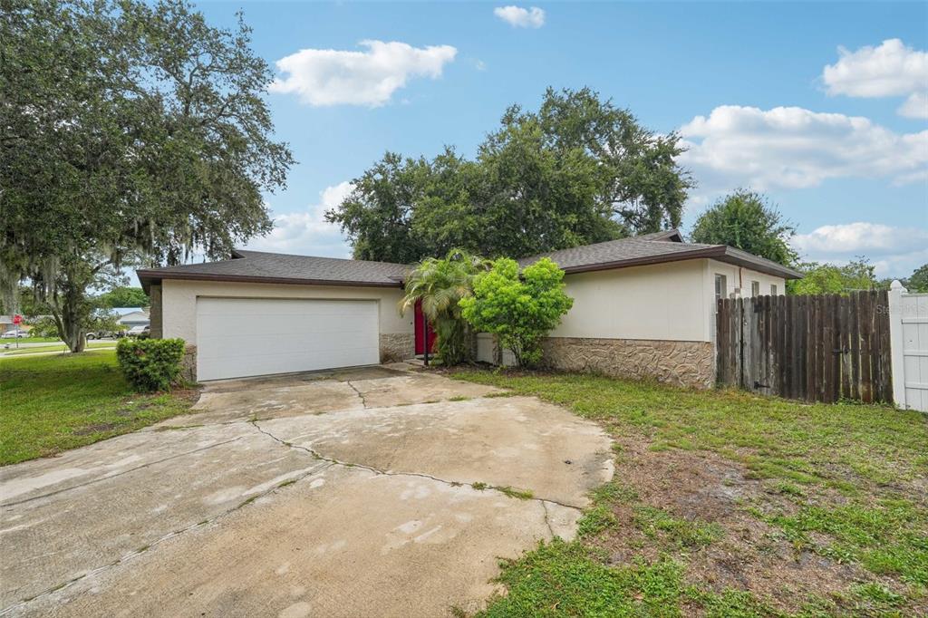 a view of a house with a yard and garage