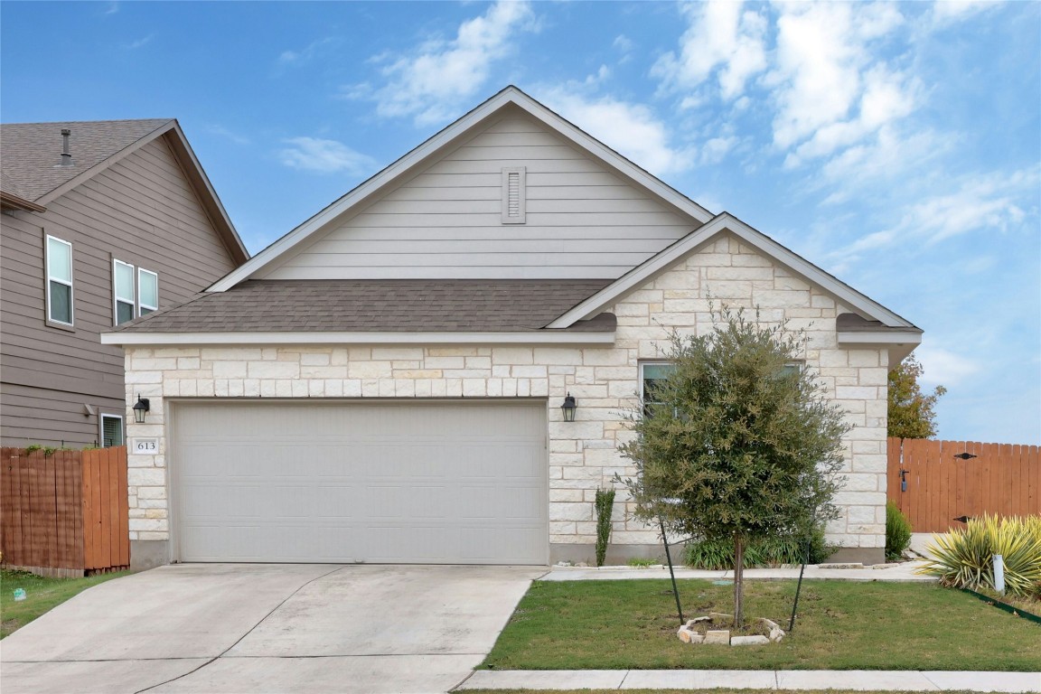 a front view of a house with a yard garage and outdoor seating