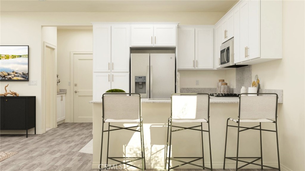 a kitchen with stainless steel appliances granite countertop a cabinets and a refrigerator