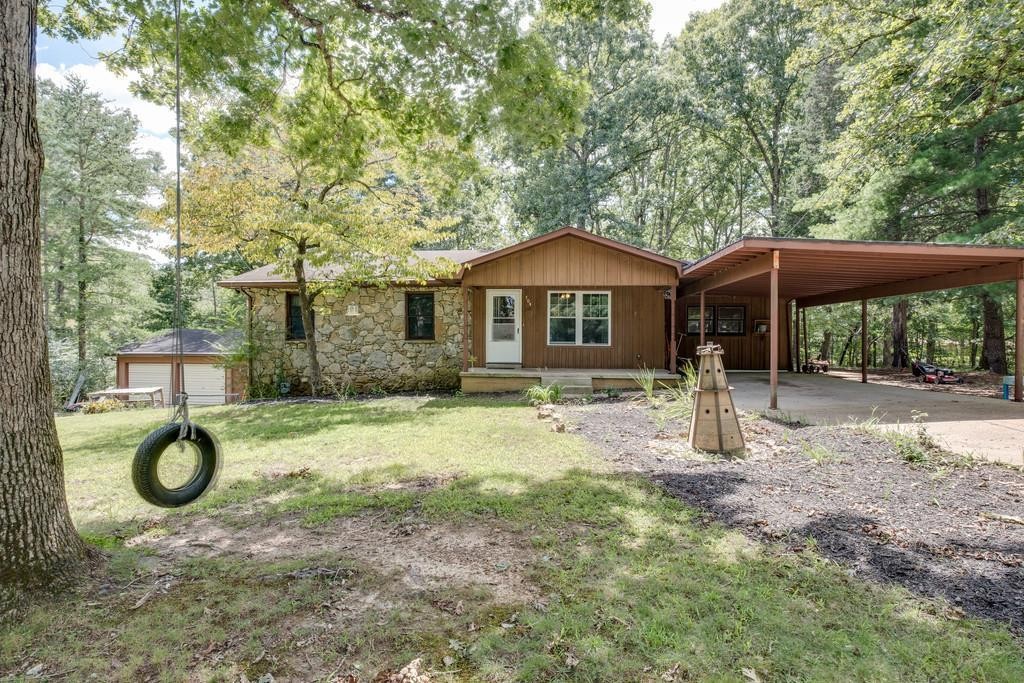 a backyard of a house with table and chairs