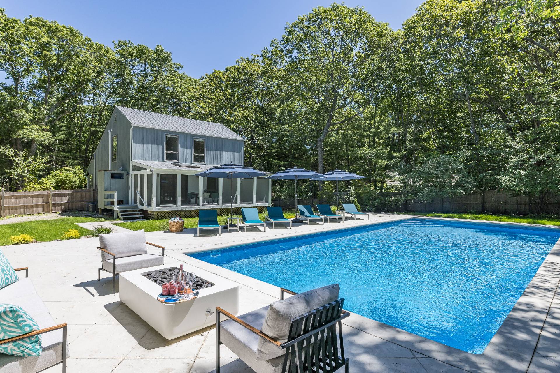 a view of swimming pool with chairs and garden