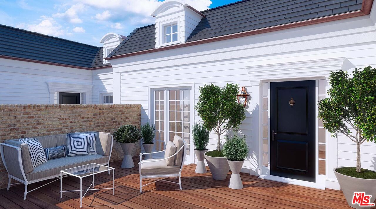 a view of a patio with couches table and chairs and potted plants