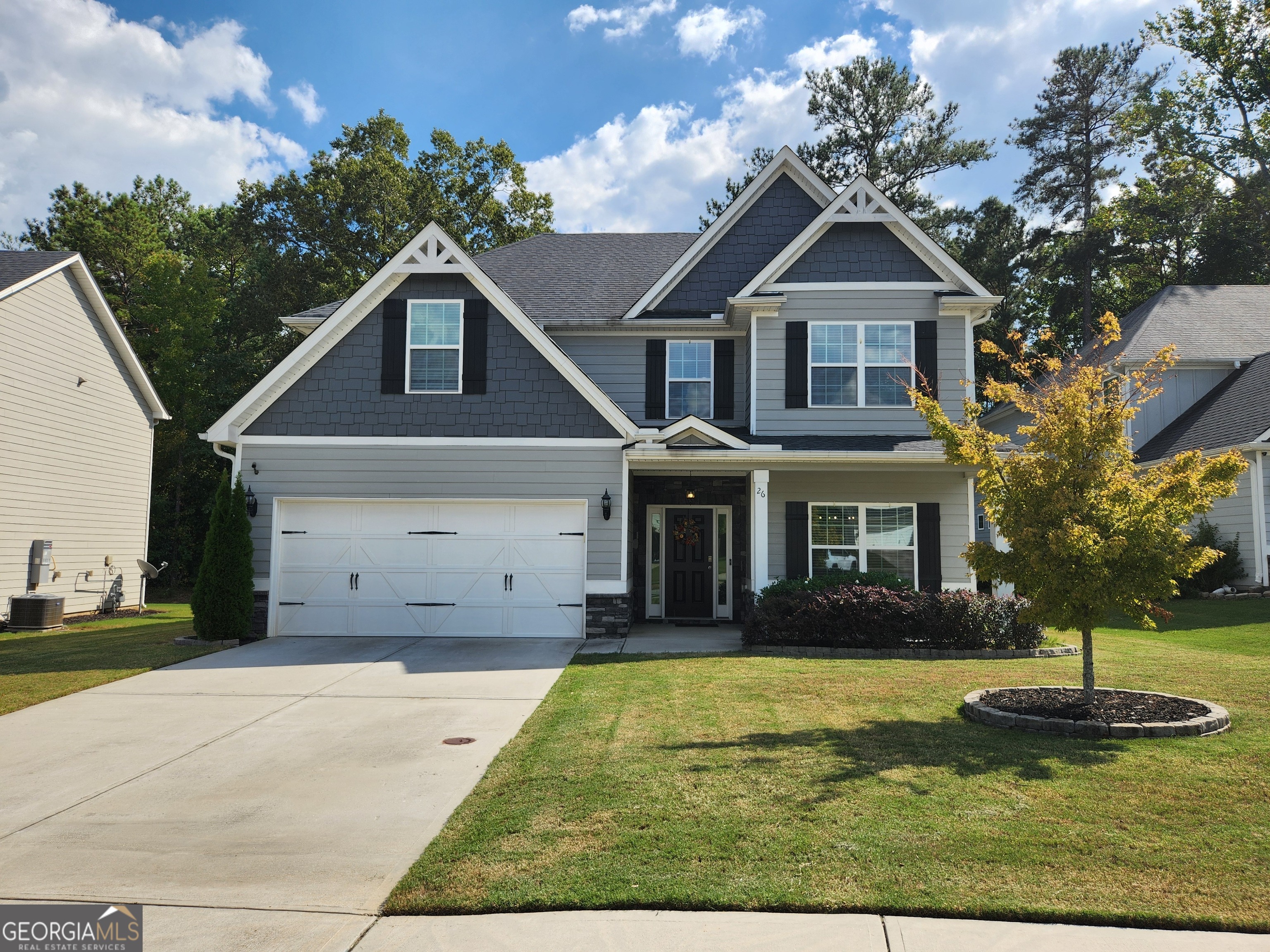 a front view of a house with garden