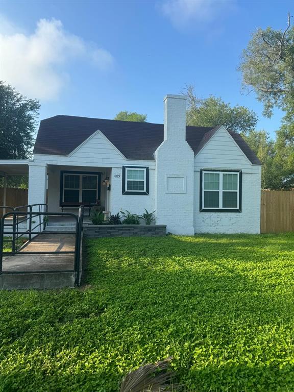 a front view of a house with a garden