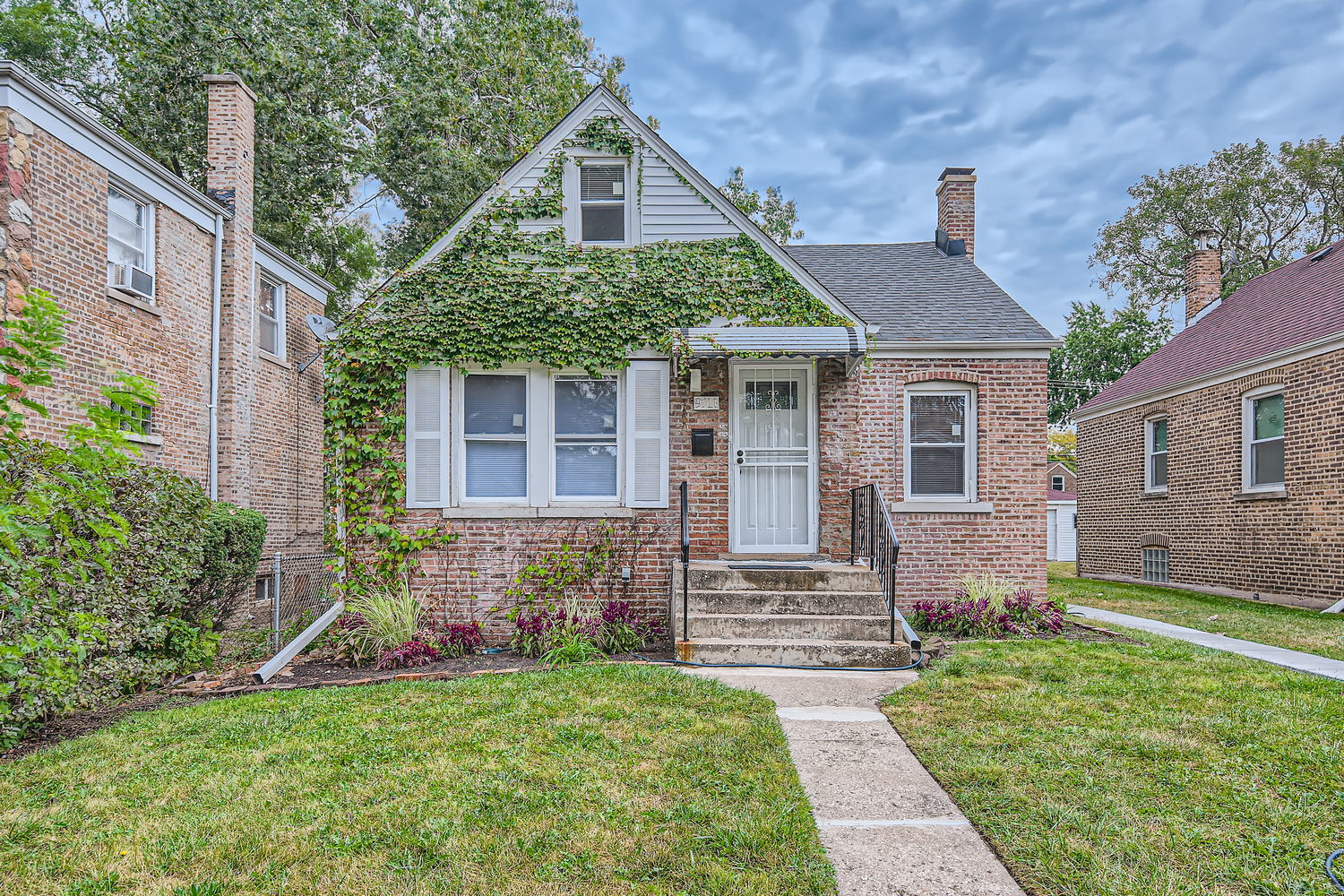 a front view of a house with garden