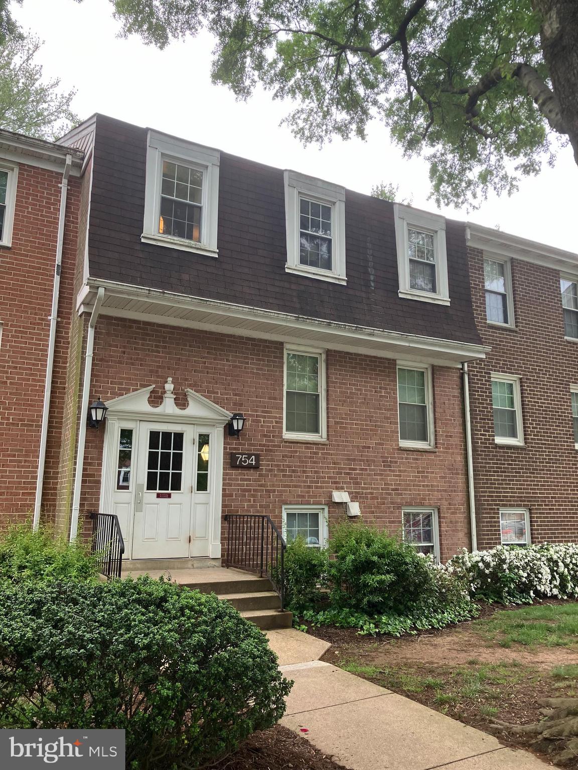 a front view of a building with a yard