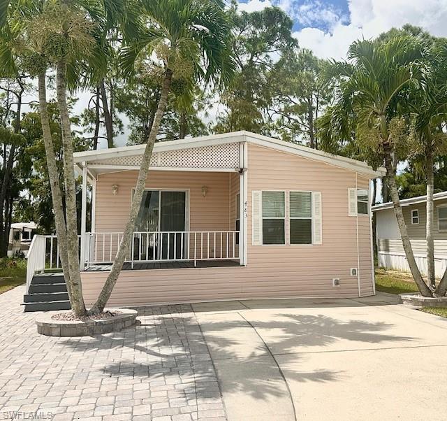 Rear view of property with covered porch