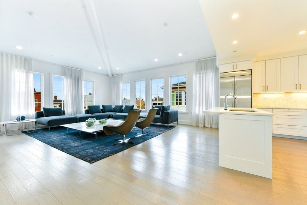 a view of a living room and kitchen with a table chairs