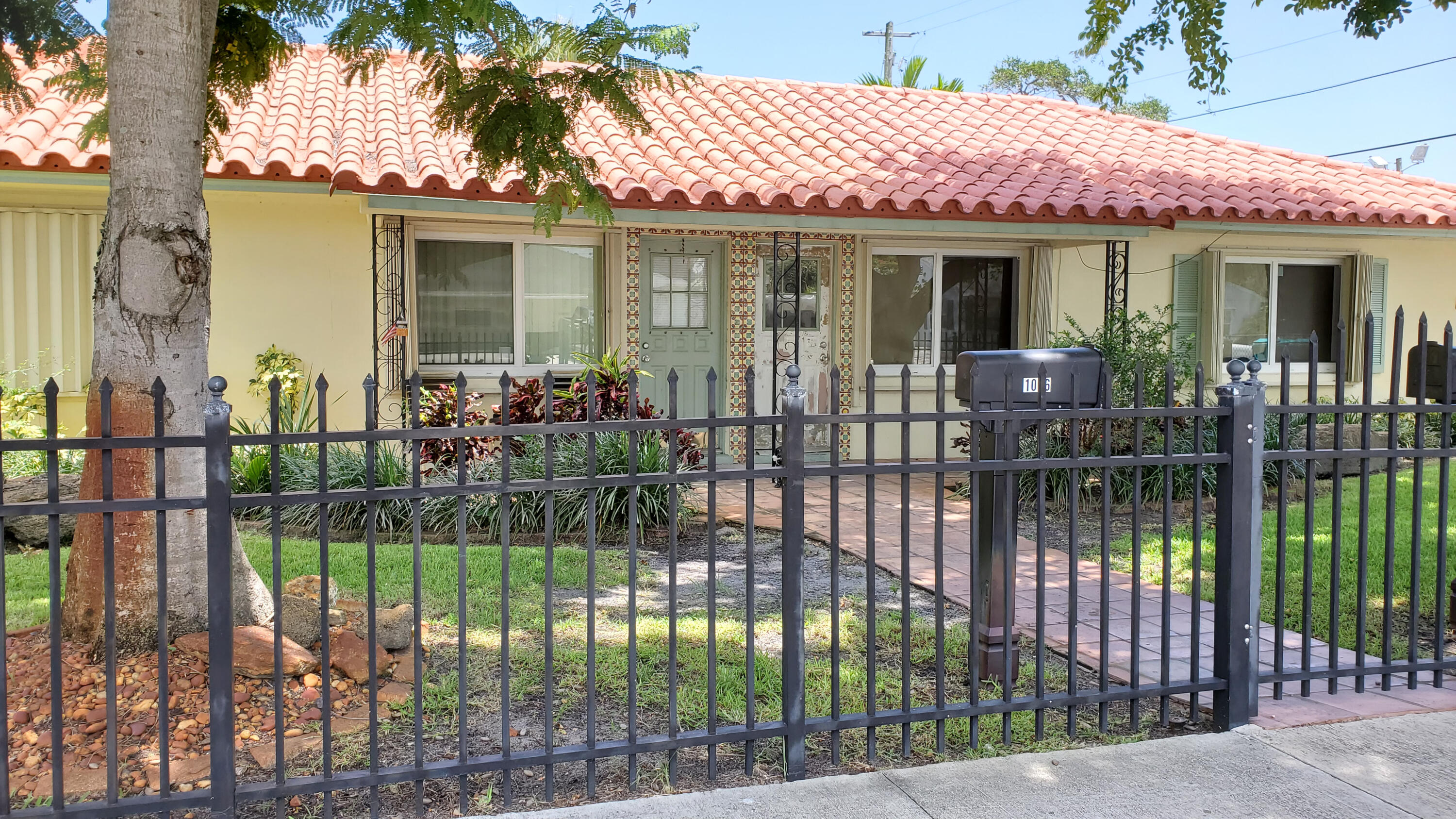 a front view of a house with a garden