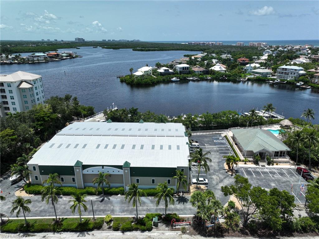 an aerial view of a house with a garden and lake view