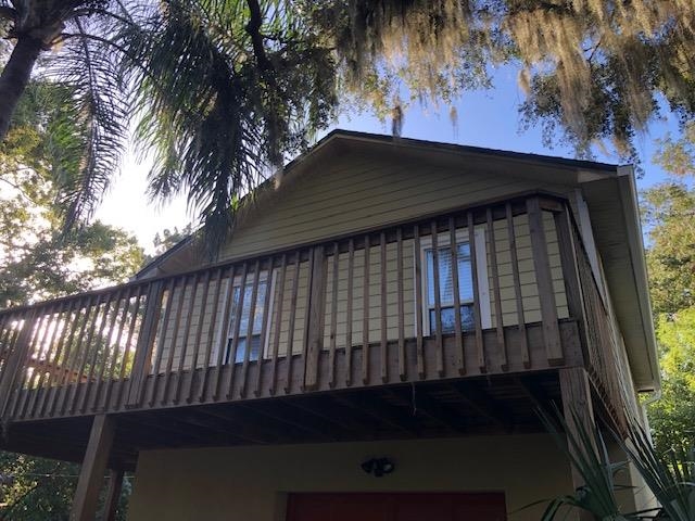 a view of a balcony with a yard