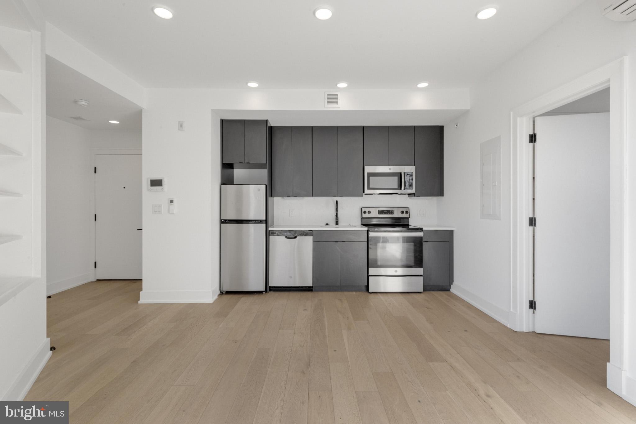 a kitchen with stainless steel appliances a refrigerator and a stove top oven