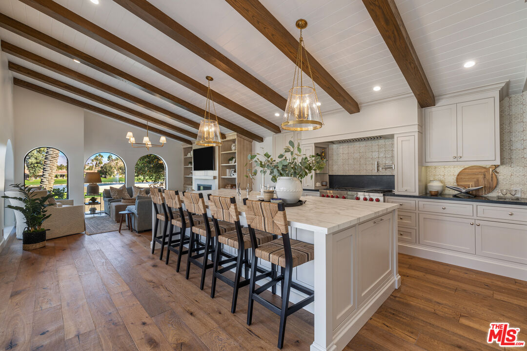 a large kitchen with a table and chairs