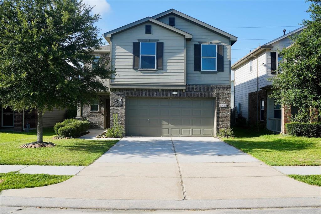 a front view of a house with a yard and garage