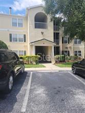 a view of a cars park in front of a building