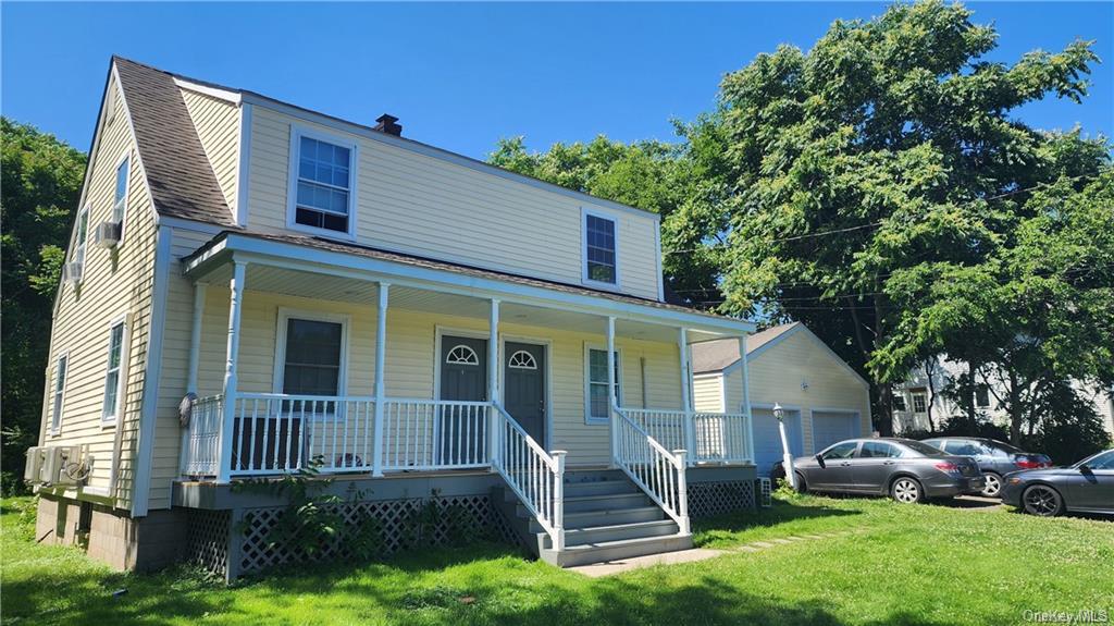 a front view of a house with a yard table and chairs