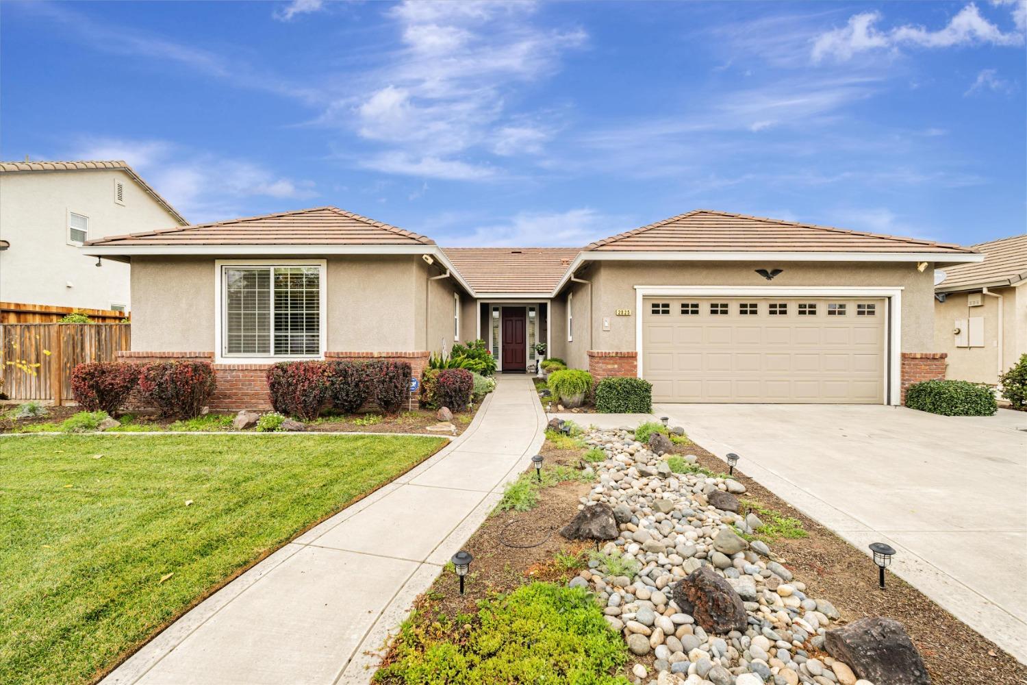 a front view of a house with a yard