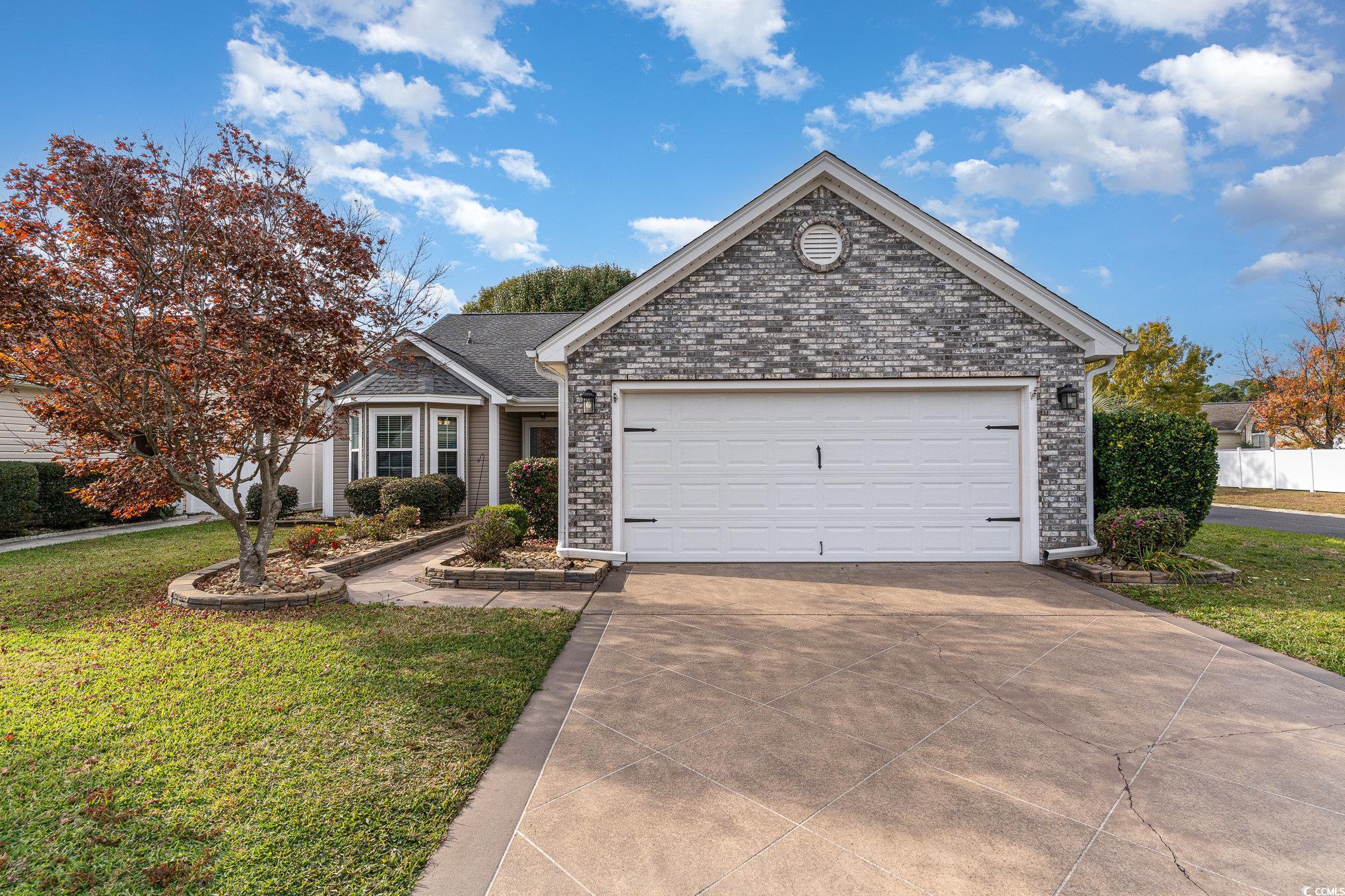 View of front of property with a garage and a fron