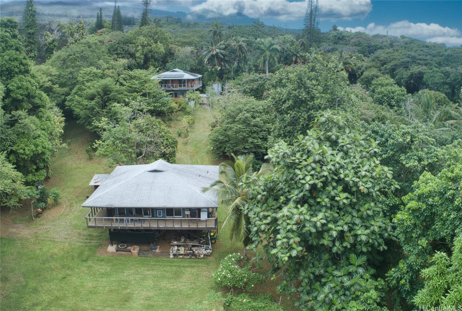 an aerial view of a house with a yard and a swimming pool