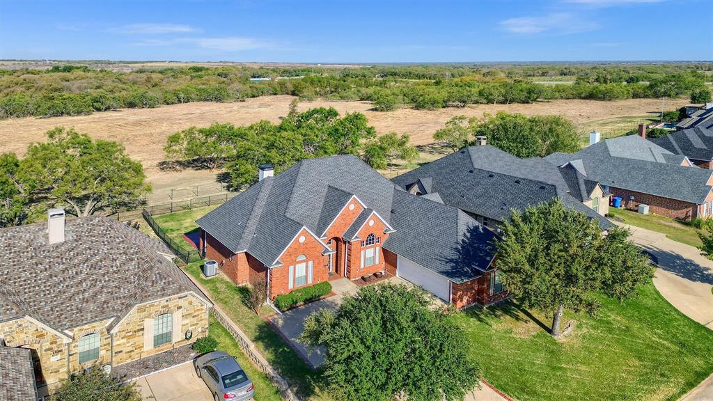 an aerial view of house with yard and ocean view