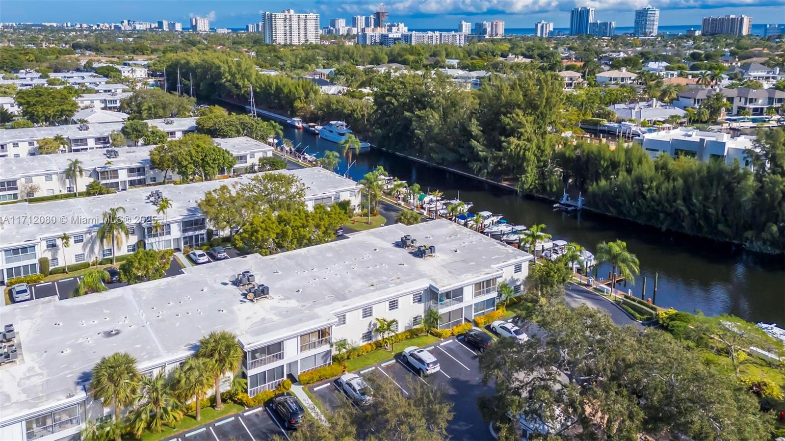 an aerial view of lake and residential houses with outdoor space