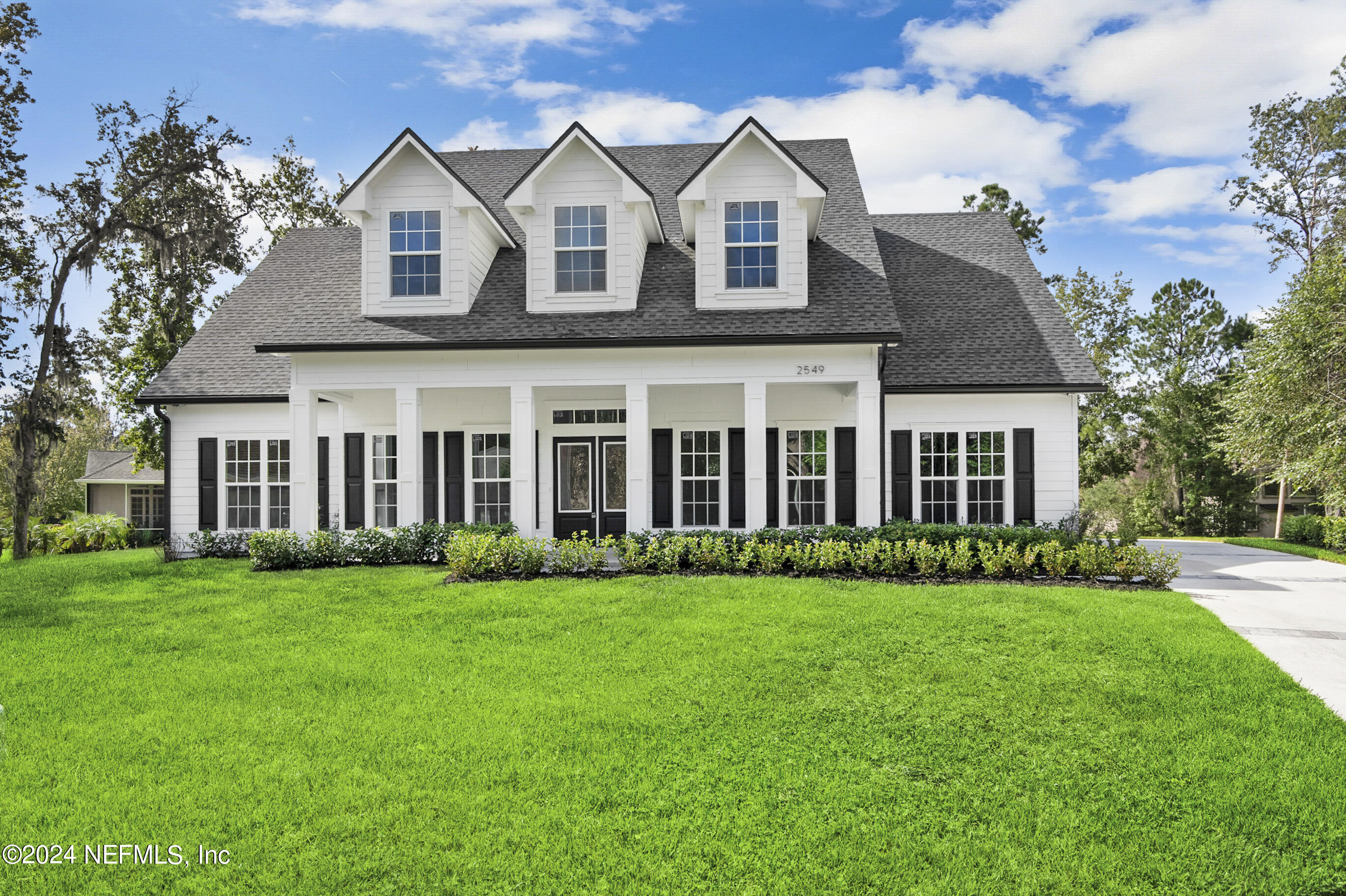 a front view of house with yard and green space