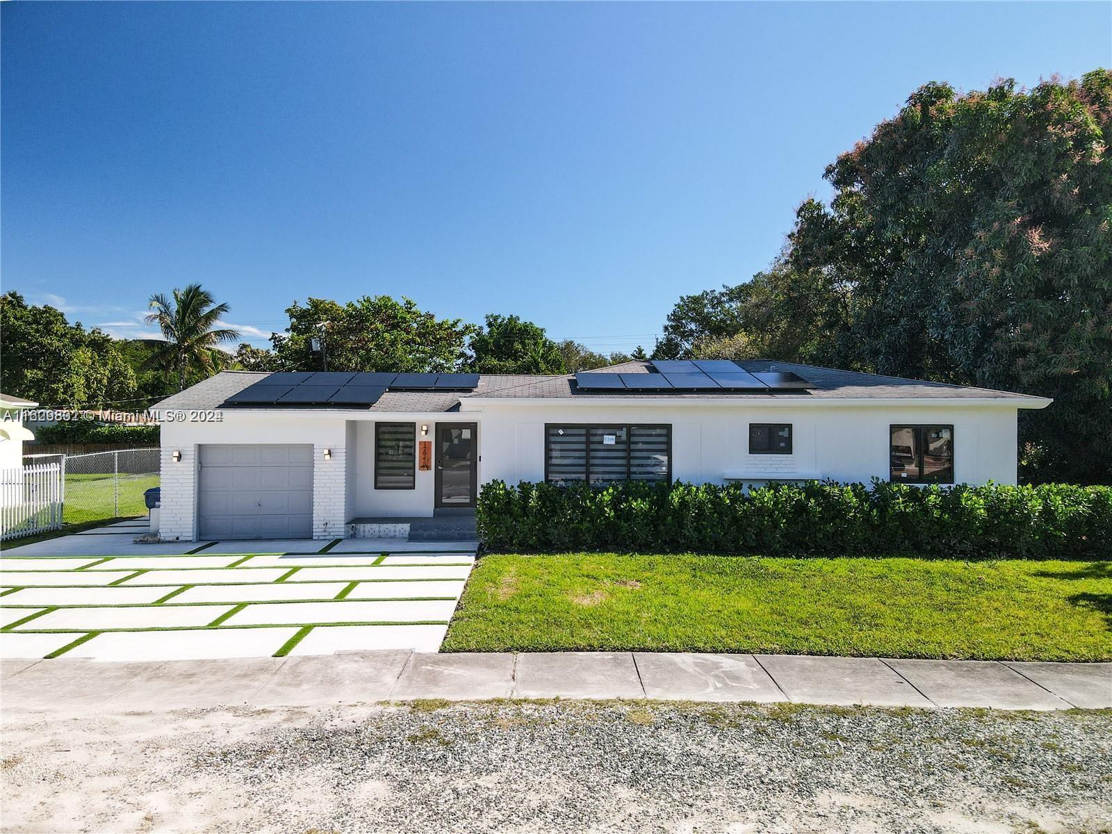 a house that has a tree in front of it