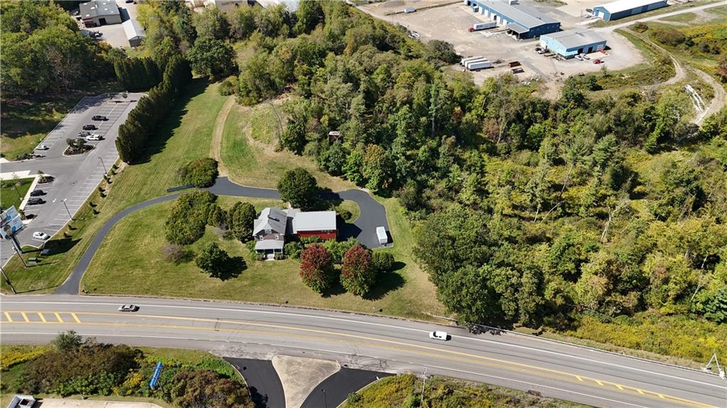 an aerial view of a house with a yard and garden