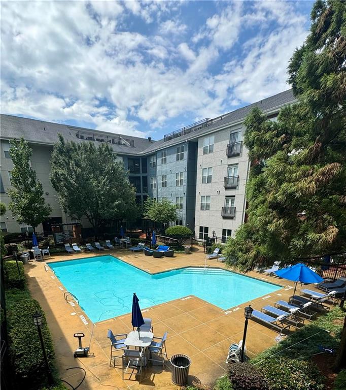 a view of a swimming pool with lounge chairs in patio