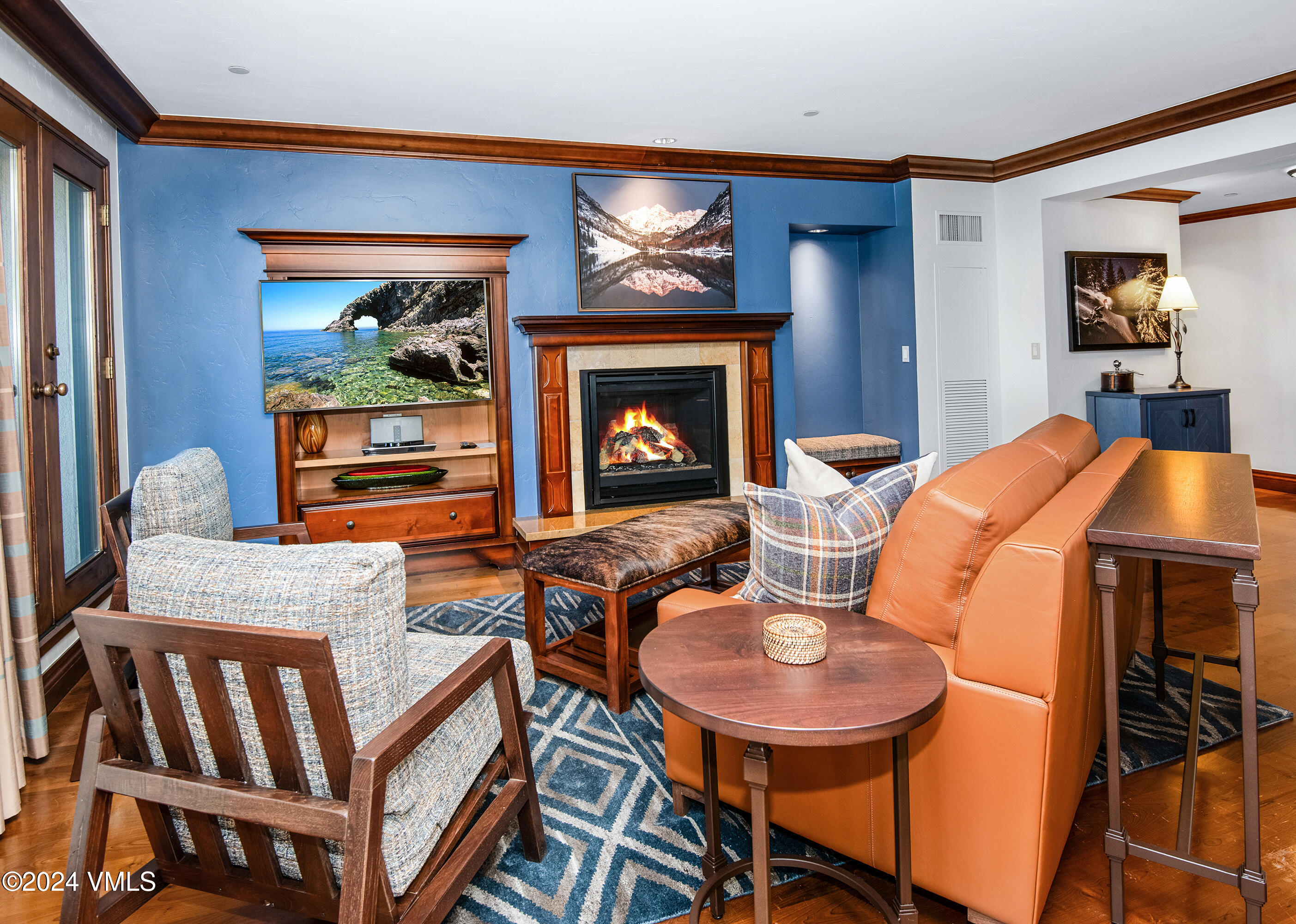 a living room with furniture a fireplace and a flat screen tv