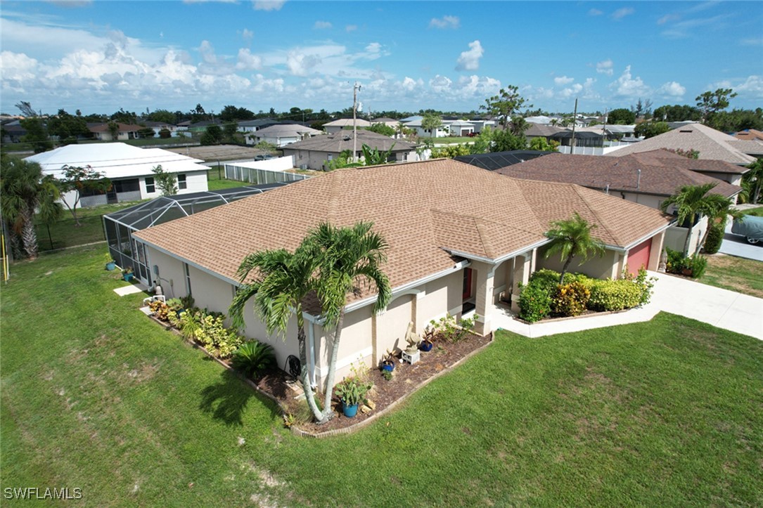 an aerial view of a house with yard swimming pool and outdoor seating